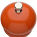 An orange and yellow pepper mill with silver knobs.