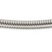 A close-up of Equip by T&S stainless steel flexible hose with a spiral wire.