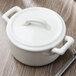 A white Bon Chef porcelain cocotte lid on a white pot.