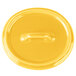 A yellow Bon Chef porcelain oval lid with a handle.