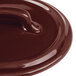 A close-up of a Bon Chef Burnt Umber porcelain cocotte lid with a handle.