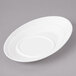 A white Bon Chef porcelain saucer with a circular design on a gray surface.