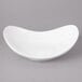 A white Bon Chef porcelain pasta bowl with a curved edge.