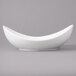 A close-up of a white Bon Chef Globe porcelain pasta bowl with a curved shape.