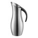 A brushed stainless steel pitcher with a black handle.