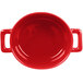 A close up of a red Bon Chef oval cocotte with handles.