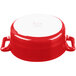 A red and white porcelain oval cocotte with a handle.