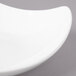 A white porcelain Bon Chef salad bowl with a curved edge.
