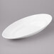 A white oval slanted porcelain bowl with a rim.