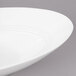 A white Bon Chef slanted oval bowl with a curved rim.