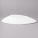 A slanted white porcelain bowl with an oval shape on a white background.
