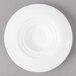 A white Bon Chef porcelain plate with a spiral pattern.