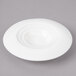 A white plate with a circular pattern and a hole in the middle.