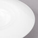 A close up of a Bon Chef white porcelain sampler plate with a swirl pattern.