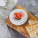 A Bon Chef white porcelain sampler plate with a slice of bread and salmon.