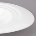 A white Bon Chef porcelain oval bowl with a curved rim.