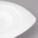 A Bon Chef white porcelain bowl with a curved edge.