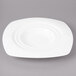 A white Bon Chef porcelain bowl with a square edge and a circular spiral pattern.