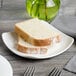 A white Bon Chef porcelain plate with a slice of bread on it.