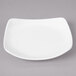A white square porcelain bread and butter plate with a curved edge.