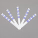 A group of five 3M Frying Oil Test Strips with white and blue sections.