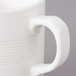 A white Bon Chef porcelain mug with stacked lines and a handle.