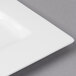 A close-up of a white rectangular Bon Chef bone china plate with a square edge.