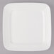 A white porcelain square plate with black circle and line accents.