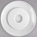 A white plate with a white circular lid with a hole in the center.