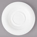 A close-up of a Bon Chef white porcelain demi saucer with a circular rim.