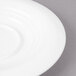 A close-up of a Bon Chef white porcelain demi saucer with a rim.