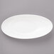 A white slanted oval porcelain bowl.