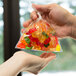 A hand holding a LK Packaging plastic food bag of gummy bears.