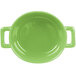 A close up of a green Bon Chef porcelain oval cocotte with handles.