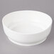 A white Bon Chef porcelain bowl on a gray surface.