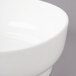 A close-up of a Bon Chef white porcelain bowl with a white rim.