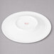 A white porcelain saucer with concentric circles on it.