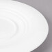 A close-up of a Bon Chef white porcelain saucer with a circular rim.