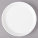 A white Bon Chef porcelain plate with a white rim on a gray surface.