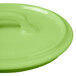 A close up of a Bon Chef lime green porcelain oval cocotte lid with a handle.