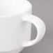A close-up of a white Bon Chef espresso cup with a handle.