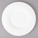 A Bon Chef white porcelain dinner plate with a rim.