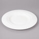 A white Bon Chef porcelain dinner plate with a circular design on the rim.