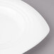 A close-up of a white Bon Chef soft square salad plate with a curved edge.