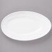 A white Bon Chef oval porcelain plate with a slanted edge.