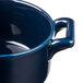 A close up of a Bon Chef cobalt blue porcelain cocotte with handles.