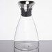 A GET Silhouette glass decanter with a metal lid.