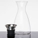 A GET Silhouette glass decanter with a stainless steel lid.