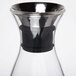 A clear glass GET Silhouette decanter with a stainless steel lid.