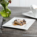 A Bon Chef white bone china square plate with pastries and a cup of coffee on it.